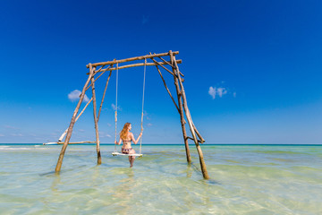 Young woman on swing Phu Quoc