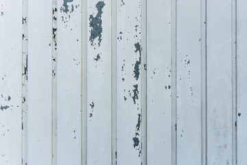 Aged metal door with white cracked paint. Rusty. Texture.