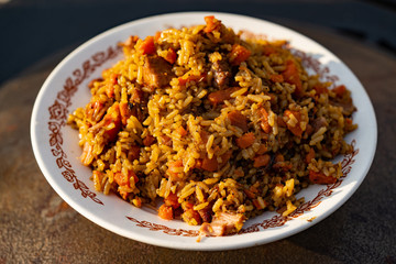 Pilaf in a plate. Rice with meat.