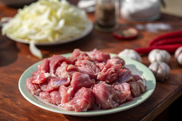 The meat of a young lamb. Fresh meat in a plate. Ingredients for pilaf

