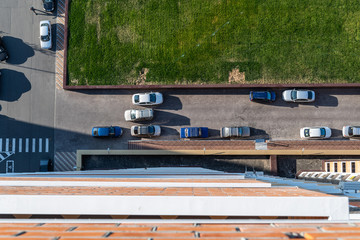 Yard with parking for cars and green grass, top view.