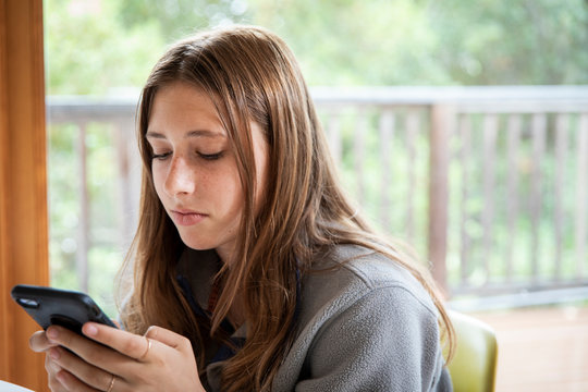A teenage girl on her smart phone during the shelter in place order