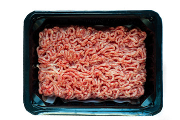 Raw minced meat on a plastic black plate, white isolated background