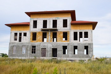 Houses under construction in suburbs. Construction of new houses and buildings.