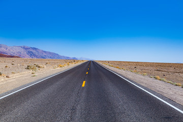empty road through  the death valley desert