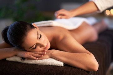Obraz na płótnie Canvas Relaxed woman receiving back massage