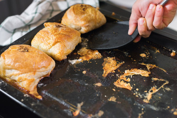 Female hands is taking a freshly baked samsa