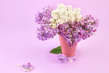 lilac in a vase on a pink background. Form for cards for spring, Easter, mother's day, women's day, Valentine's Day. top view, copy space