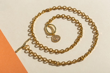 Women's Jewelry. Trendy jewelry on coloured background. Flat lay, top view.