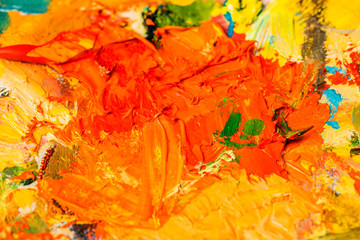 Background image of bright oil-paint palette closeup.