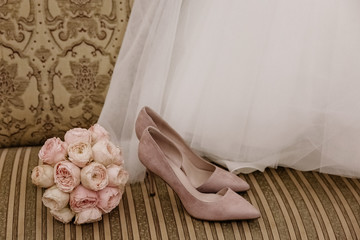 Wedding shoes on a bed