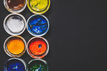 white lids from jars of paint with remnants of paint on the back, background for the artist. Copy space