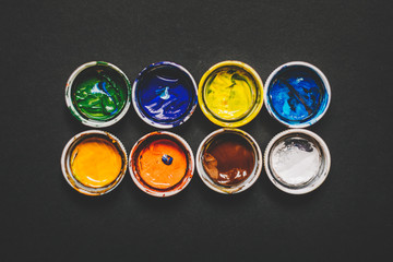 white lids from jars of paint with remnants of paint on the back, background for the artist. Copy space