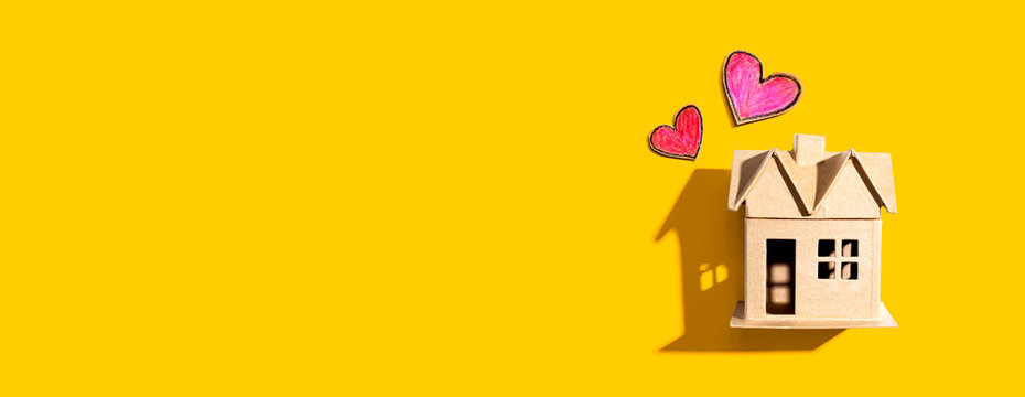 Cardboard house with heart crayon drawings - flatlay