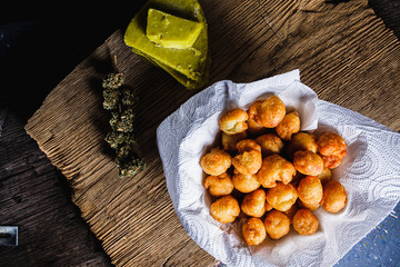 churros balls spanish donuts from medical cannabis butter, sugar, flour, egg. marijuana buds. medical cannabis butter. On a old wooden. horizontal.