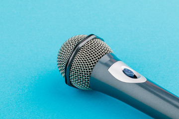 Vocal audio microphone on a blue background.