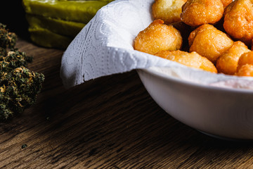 churros balls spanish donuts from medical cannabis butter, sugar, flour, egg. marijuana buds. medical cannabis butter. On a old wooden. horizontal.