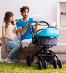 Young parents with baby expecting new arrival