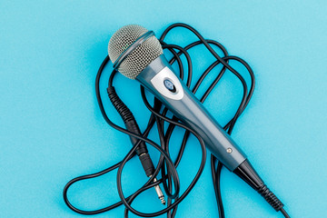 Vocal audio microphone on a blue background.
