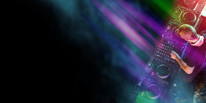 Disc jockey at the turntable. DJ plays on the best, famous CD players at nightclub during party.