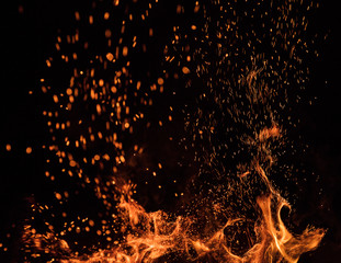 Fototapeta na wymiar fire flames with sparks on a black background, close-up