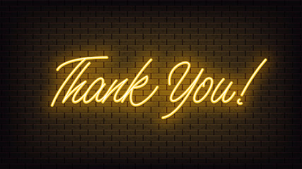 Yellow neon Thank You, lettering. Neon text of Thank You on black brick background