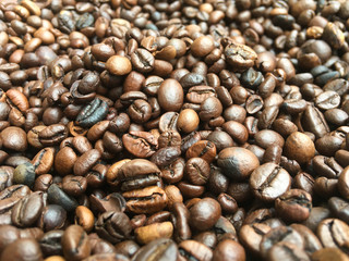 large roasted coffee grains, background texture from coffee beans
