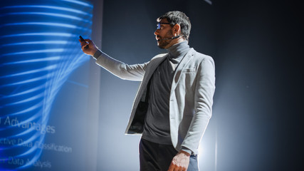 On-Stage: Handsome Speaker Does Presentation, New Product Release, Shows Infographics, Statistic...