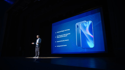 Live Event with Brand New Products Reveal: Speaker Presents Smartphone Device to Audience. Movie...