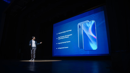 Live Event with Brand New Products Reveal: Speaker Presents Smartphone Device to Audience. Movie...