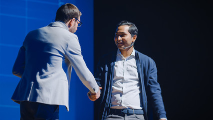 On Stage: Startup CEO Greets Tech Guru During Presentation of a New Product. Speakers Lead Lecture...
