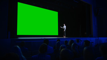 Inspirational Speaker Does Presentation New Product to Audience, Behind Her Movie Theater with Green Screen, Mock-up, Chroma Key. Female CEO Shows Leadership on Business Live Event or Device Reveal