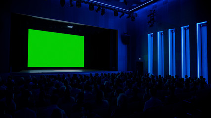 In Movie Theater Captivated Audience Watching New Blockbuster Film on Mock-up Green Screen. People...