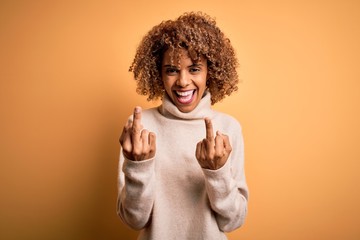 Young beautiful african american woman wearing turtleneck sweater over yellow background Showing...