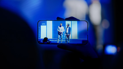Audience Use Smartphones to Record Two Speakers Talking on Business Conference. Public Uses Mobile...