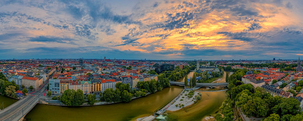 Dramatic sky at sunrise over Munich as panoramic aerial with a wonderful wide view over the...