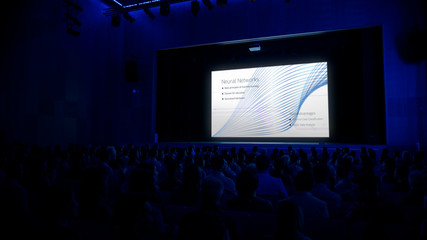 In the Modern Movie Theater Captivated Audience Watching Presentation of New Neural Networks. New...