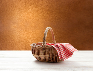 Fototapeta na wymiar empty basket with red napkin picnic on table place