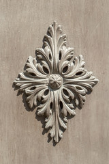 Vintage Relief on the ceiling. Decorative plant ornament on the wall.