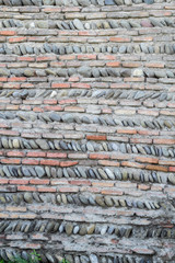 Ancient masonry walls of brick and pebbles.