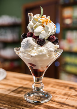 dessert cup with red fruits and whipped cream
