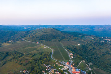 A fragment of a high-altitude village with plowed and sown fields and developed infrastructure. Aerial photography.