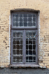 Fototapeta na wymiar Legacy retro prison wall with old worn out prison cell window.