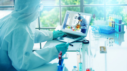 Scientist are experiment with science on vaccines to treat Coronavirus. Analysis meeting through video conference with a laptop. Working in a lab via video call. Concept work at home and new normal