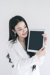 Business woman holding tablet with blank empty screen for us as mock up image for advertising and text.