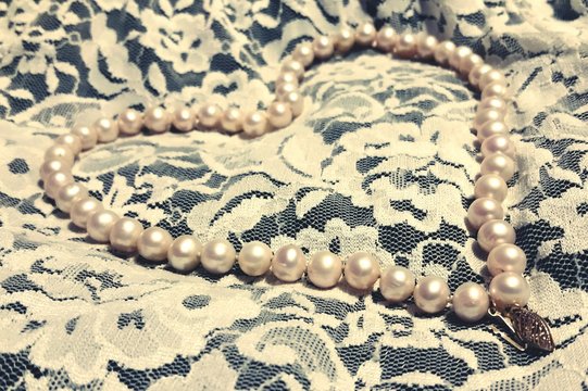 Heart Shape Pearl Necklace On Bed