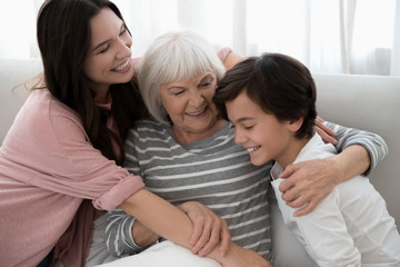 Aged woman surrounded by her loving family