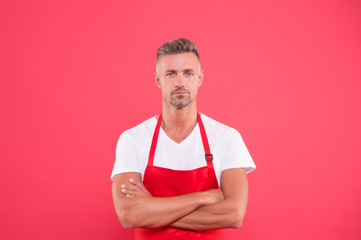 mature man in apron crossed hands. hostess of the restaurant. Fast food restaurant. Restaurant staff. man staff in uniform. Professional approach to business. welcome to our cafe