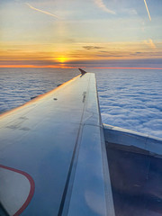 Beautiful sunset sky view through airliner porthole, mobile photo