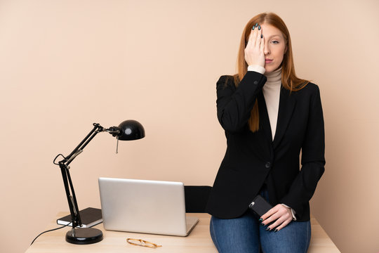 Business woman in a office covering a eye by hand